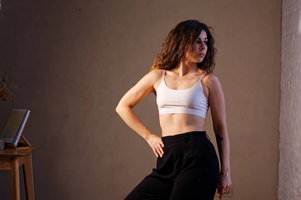 istock A young woman in white bra and black pants 2219873059
