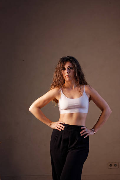 istock A young woman in white bra and black pants 2219873061