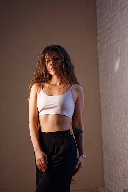 istock A young woman in white bra and black pants 2219873103