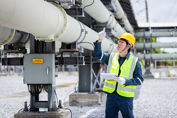 istock Engineer is working at power substation performing high voltage infrastructure inspection to check equipment and ensure safety and reliability in facility 2219873985