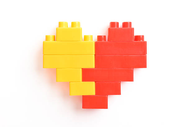 Heart of toy blocks isolated on white background, top view cut out. Plastic building blocks