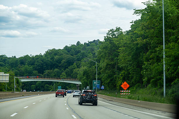 istock Traffic on a highway surrounded by lush greenery near a construction zone 2219879252