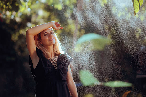 istock Woman Relaxes with a Cooling Water Sprinkler 2219880978