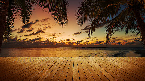 istock Empty wooden platform beside tropical sea shore during the sunset 2219881183