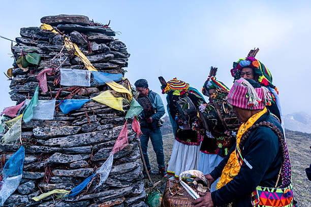 Shamans enchanting in a ritual pray at the peak of Singla Mane Hill during Buddha Jayanti in Dhading, Nepal on May 12, 2025.