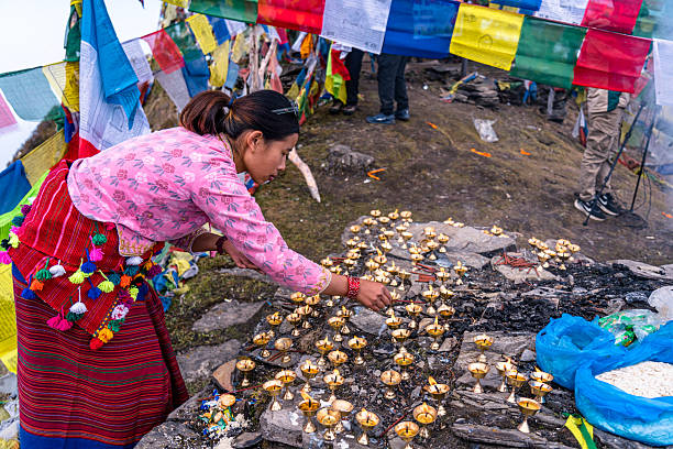 Punakha, Bhutan – March 01, 2023: Elderly Bhutanese man among Tibetan Buddhist worshipers at Tshechu festival in Punakha, Bhutan