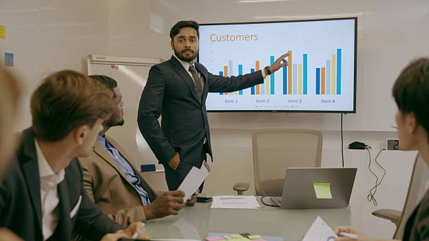 istock An office full of executives discussing 2219884686