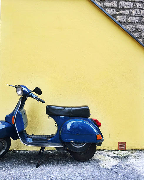 istock Blue Scooter Against Yellow Wall 2219887440