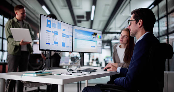 istock Team Developing Mobile Shopping App, Designer Monitoring Webinar 2219887758