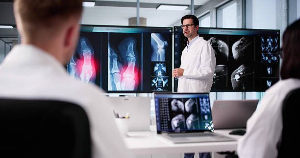 istock Radiologist And Doctor Lead Group Conference With Xray Analysis 2219888439
