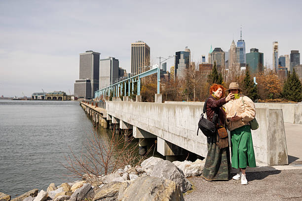istock Friends taking selfie on waterfront pier. Manhattan skyline backdrop in early spring. 2219888538