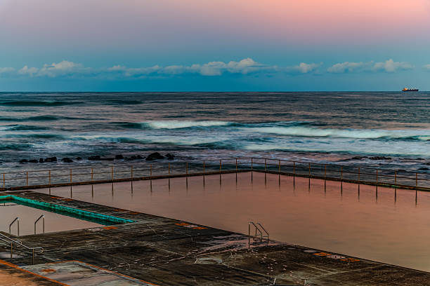 istock Sunset at the Seaside with black rocks 2219888770