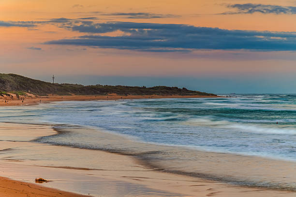 istock Sunset at the Seaside with black rocks 2219888774