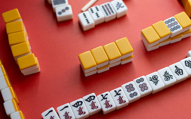 istock Mahjong tiles lined up on a red background 2219891005