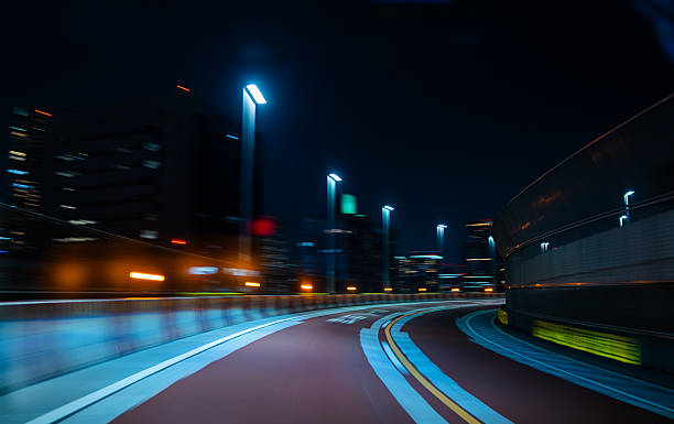 istock Curving Highway with City Lights 2219891784