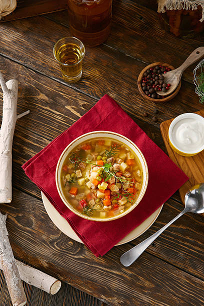 istock Minestrone soup in ceramic bowl, rustic warm lighting, overhead wooden table flatlay 2219892599