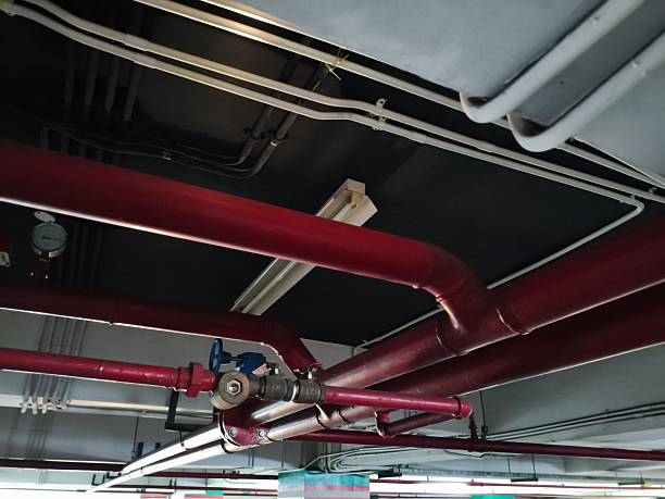 istock Overhead view of fire suppression system pipes in a building. 2219895608