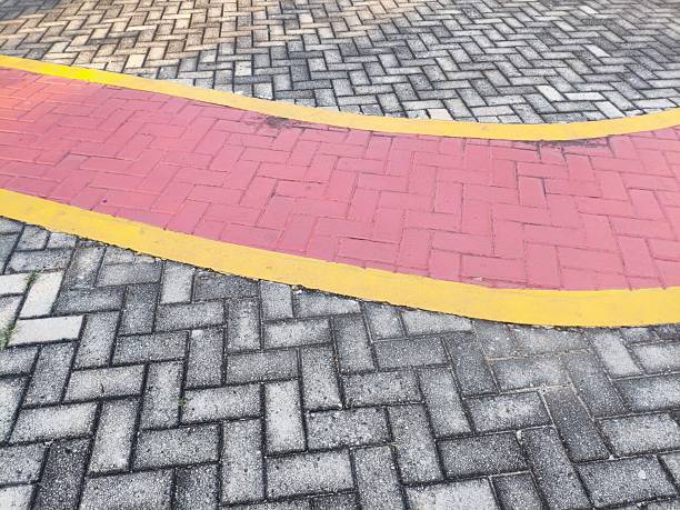 istock Red and Yellow Road Markings on Brick Pavement 2219895621