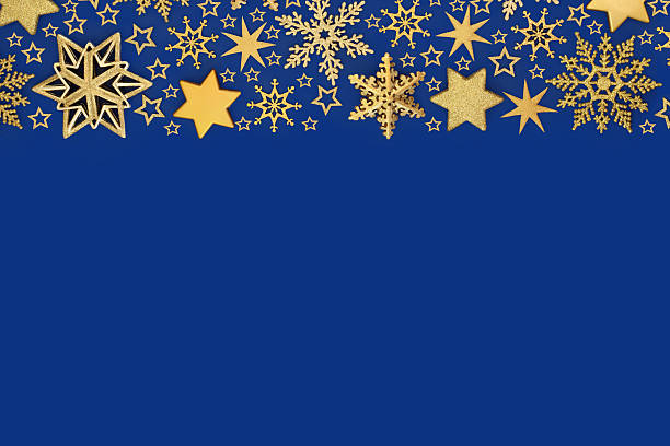 Xmas luxury bauble decorations gold stars, snowflakes, background on blue. Festive abstract design for holiday Christmas season. Greeting card.