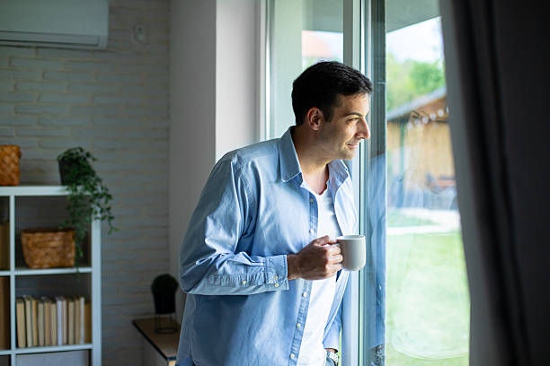 istock Man Enjoying Morning Coffee by the Window 2219904257