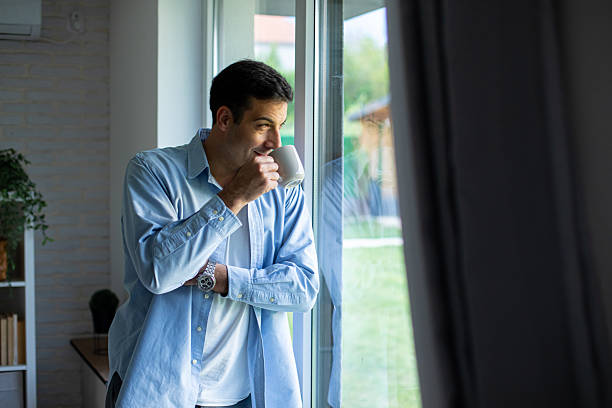 istock Man Enjoying Morning Coffee by the Window 2219904281