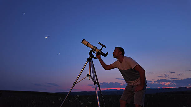istock Amateur astronomer using telescope for watching stars, Moon, planets and other celestial objects from a countryside field in nature. 2219904286