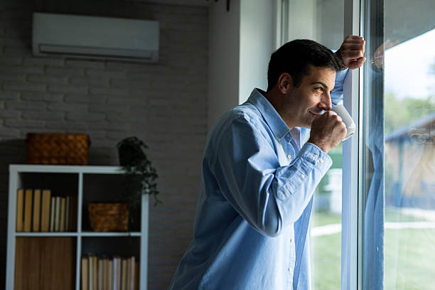 istock Man Enjoying Morning Coffee by the Window 2219904508