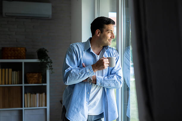 istock Man Enjoying Morning Coffee by the Window 2219904966
