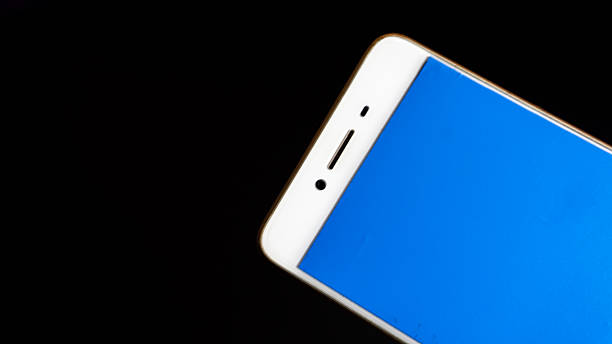 White and gold-edged smartphone with blank blue screen set on black background, perfect isolated asset for UI mockup, app presentation, or tech product display