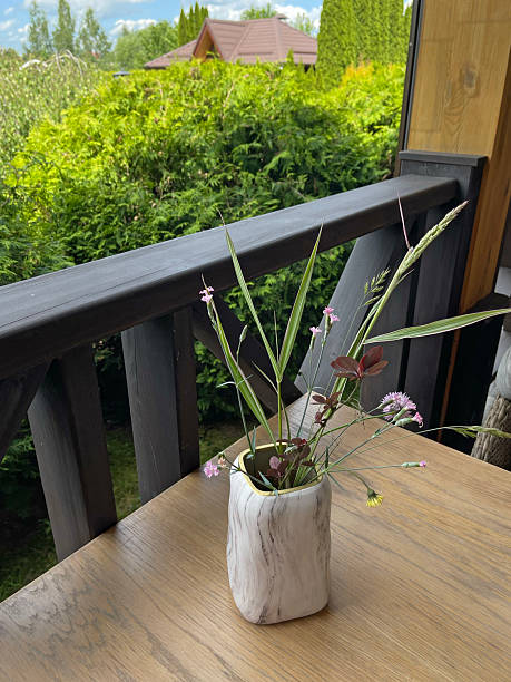 istock Marble vase with wildflowers on table. 2219907223