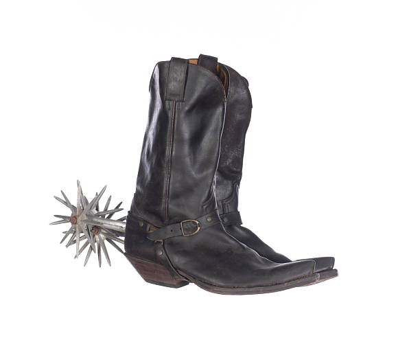 Western boot with old time spurs in stirrup.