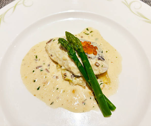 istock White fish (sea bream) with salmon roe and white sauce 2219911741
