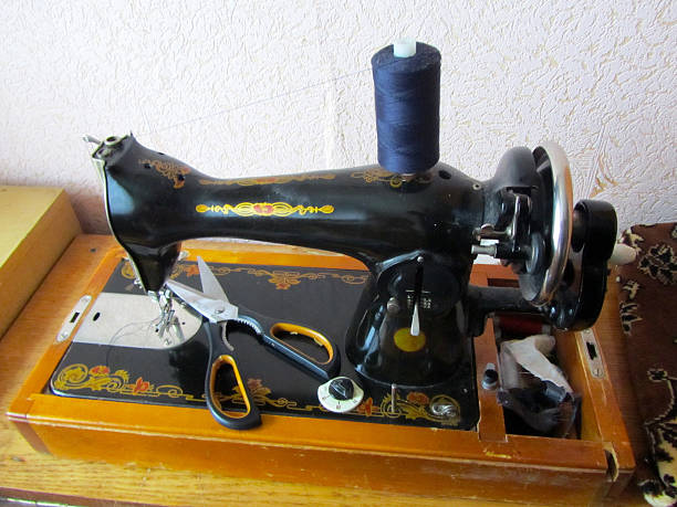istock Close-up of a vintage sewing machine with thread and scissors 2219912032