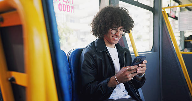 istock Cellphone, smile and man on bus online for checking university exam results on mobile app with travel. Phone, college and male student reading acceptance email on public transportation in city. 2219912253