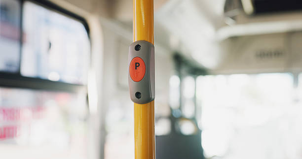 istock Travel, bus interior and button for stop request on morning commute, urban trip and tech. Empty, public transportation and switch for bell with electric system on handrail to end journey service 2219912296