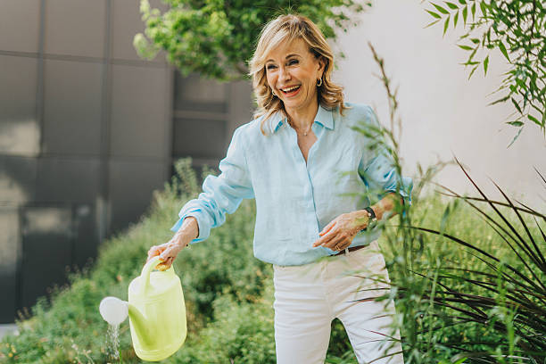 Woman spraying her flowers with water