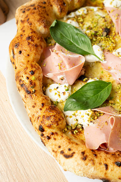 istock Pizza with mortadella at a restaurant table 2219915024