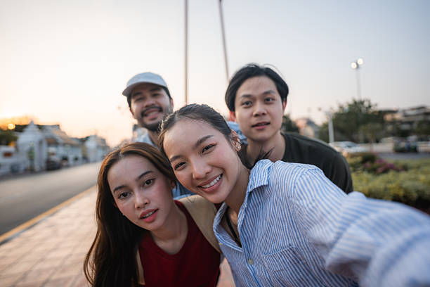 istock Group of friends taking pictures and filming themselves with digital camera while exploring the city of Bangkok 2219916207
