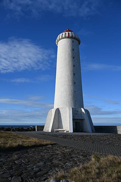 istock Striking white lighthouse against a vivid blue sky 2219916850