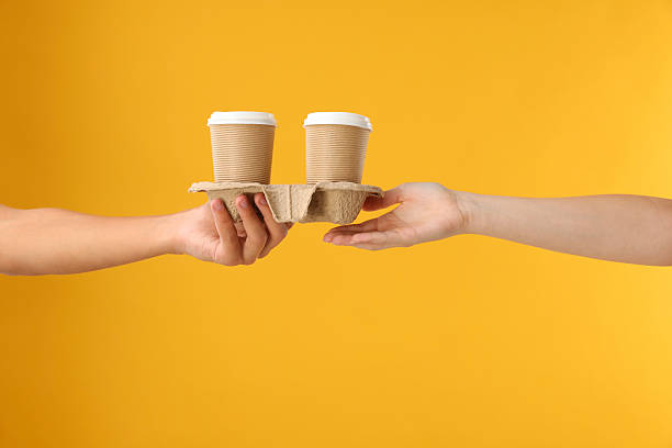 istock Fast-food worker giving customer's order on orange background, closeup 2219917291