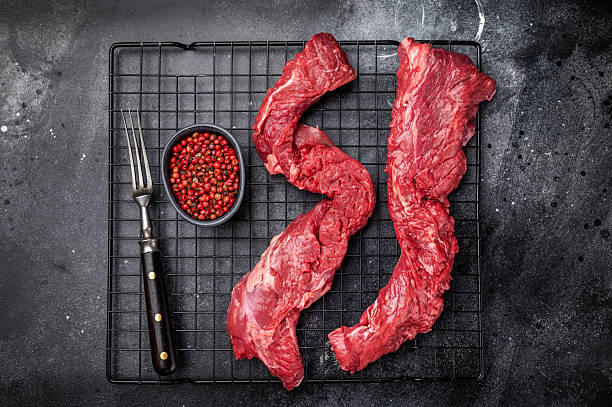 Raw Beef Steak Machete, uncooked meat . black background. top view