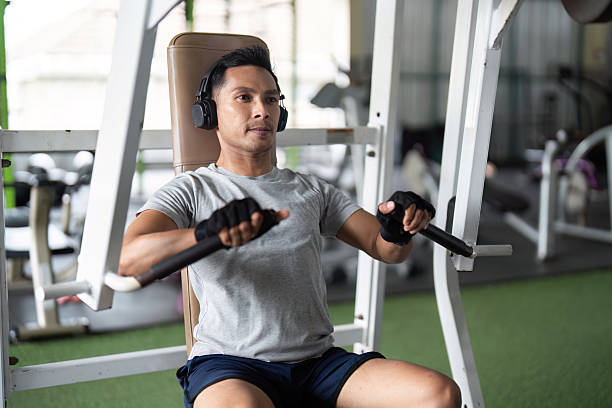 istock Focused Workout. Young man performing chest press in gym setting. 2219918844