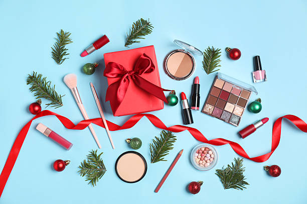 istock Flat lay composition with makeup products and Christmas decor on light blue background 2219918993