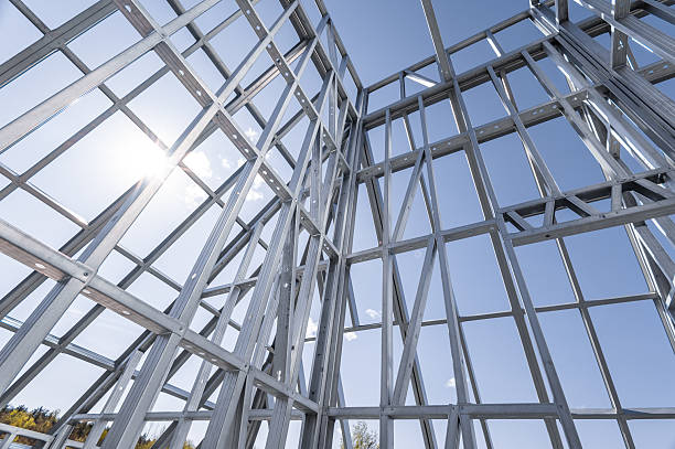 istock Building in construction, Metallic structure against a clear sky. New residential construction home metal framing. 2219922549