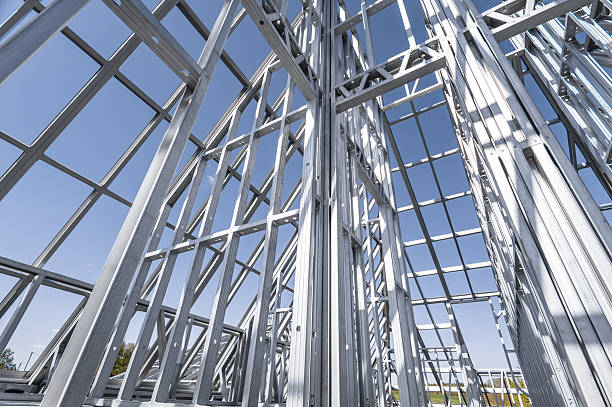 istock Building in construction, Metallic structure against a clear sky. New residential construction home metal framing. 2219922623
