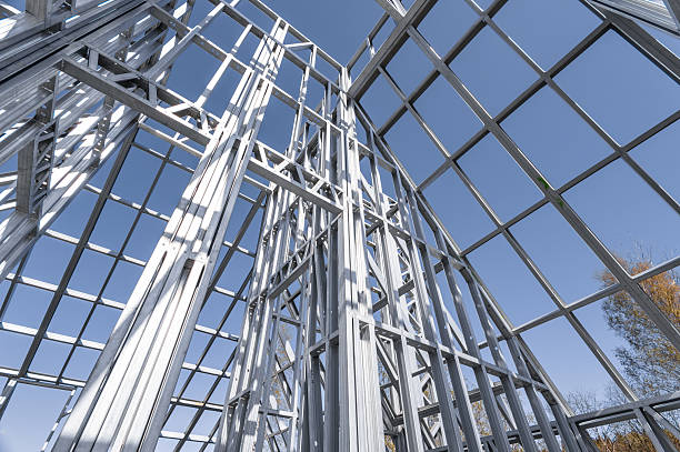 istock Building in construction, Metallic structure against a clear sky. New residential construction home metal framing. 2219922803