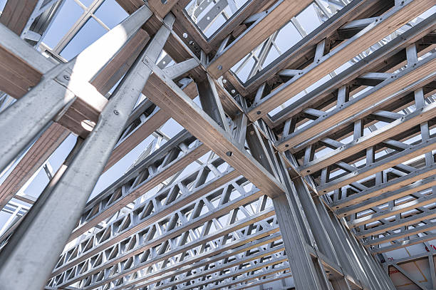 istock Building in construction, Metallic structure against a clear sky. New residential construction home metal framing. 2219922945