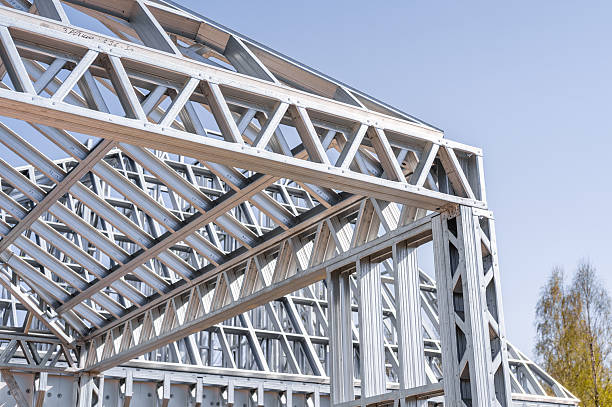 istock Building in construction, Metallic structure against a clear sky. New residential construction home metal framing. 2219923002