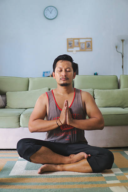istock Man Meditating Indoors in a Calm and Peaceful Home Setting 2219923403