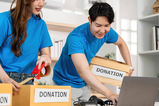 istock Donation Activity. Volunteers collaborating to pack donation boxes at a community center. 2219928557